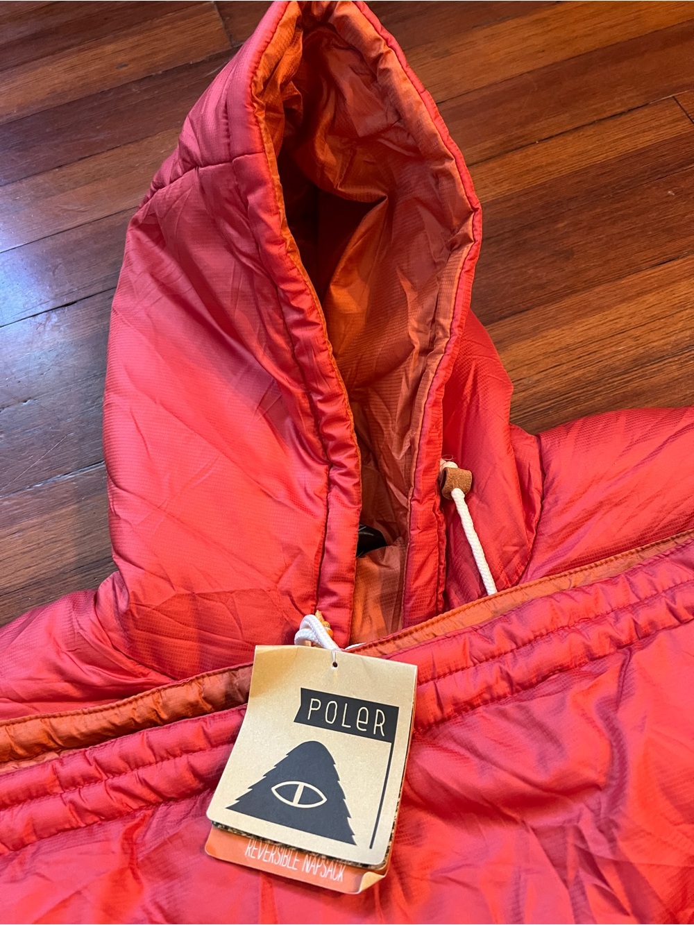 NWT - Poler reversible napsack (sleeping bag + parka) in dark red / orange
